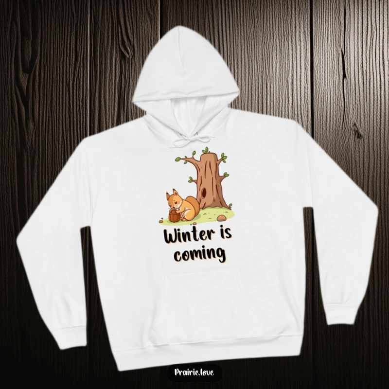 Funny hoodie showing a determined squirrel meticulously burying an acorn by a stylized tree, prepping for the future.